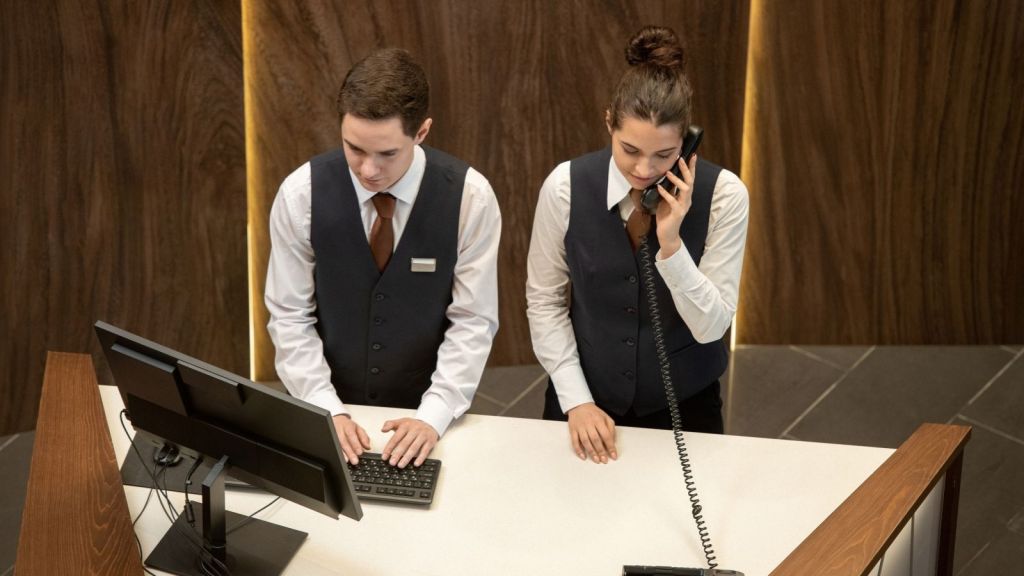 two front desk workers at a hotel
