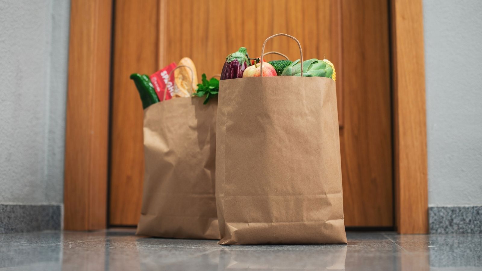 His Food Got Delivered to the Wrong House—But Walking Over to Get It Made Him Feel Like the One Who Messed Up two grocery bags of food outside a door