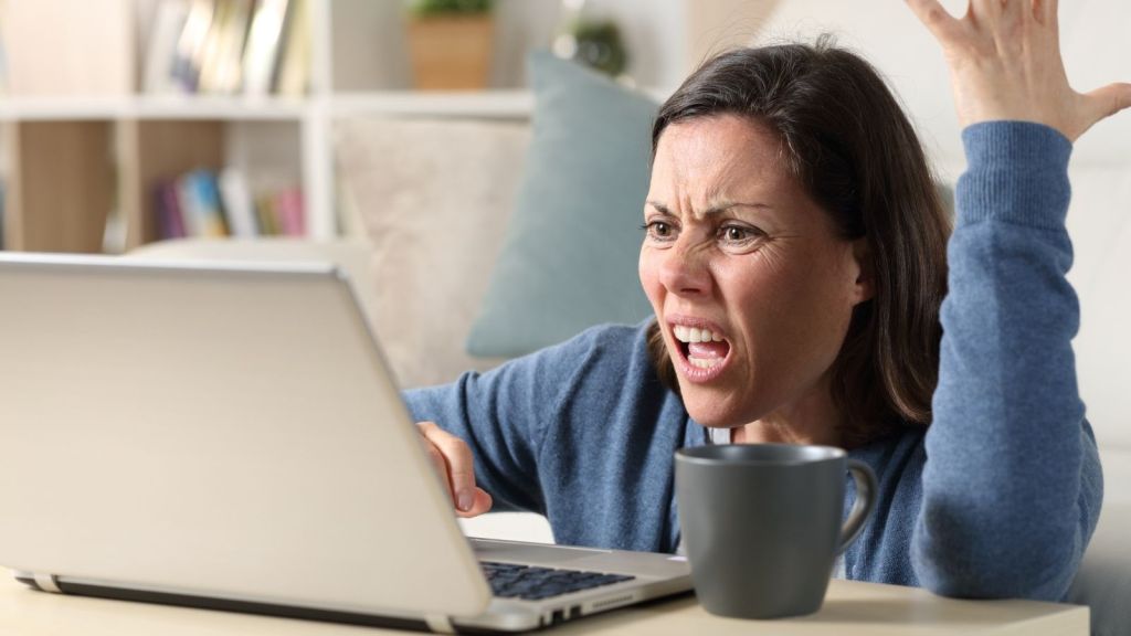 angry woman looking at her computer