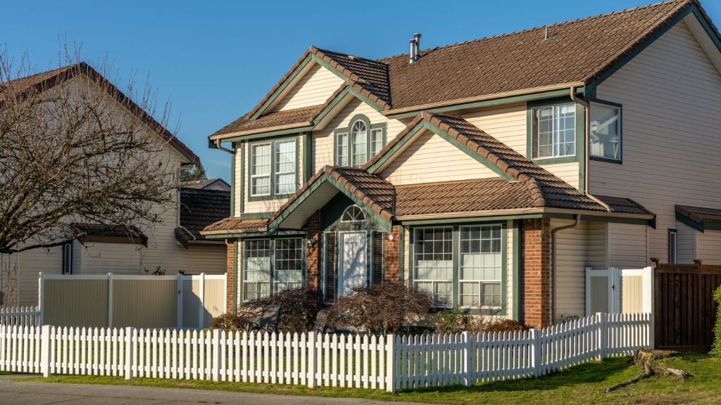 fence around a suburban house's front yard