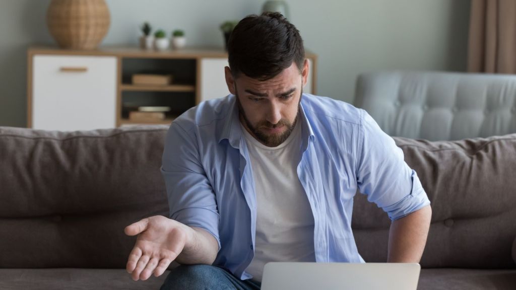 frustrated man looking at his computer