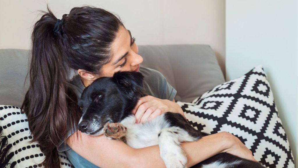 woman hugging her dog