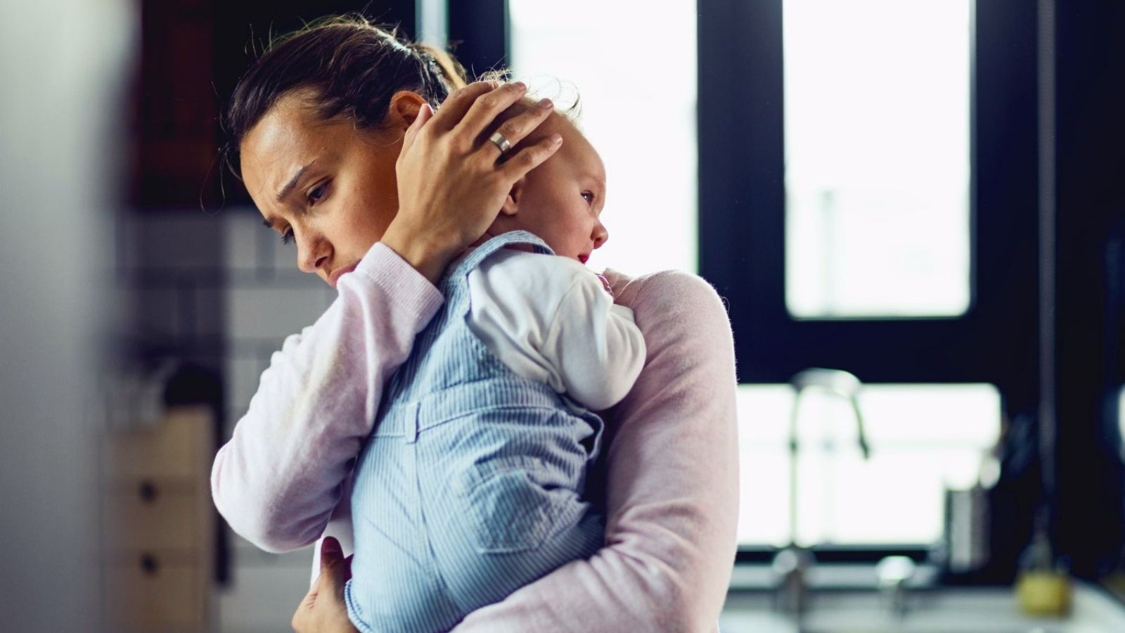 Her Husband Begged Her for a Baby—Now He’s Always Traveling for Work While She Raises Their Child Totally Alone Sad woman holding a baby