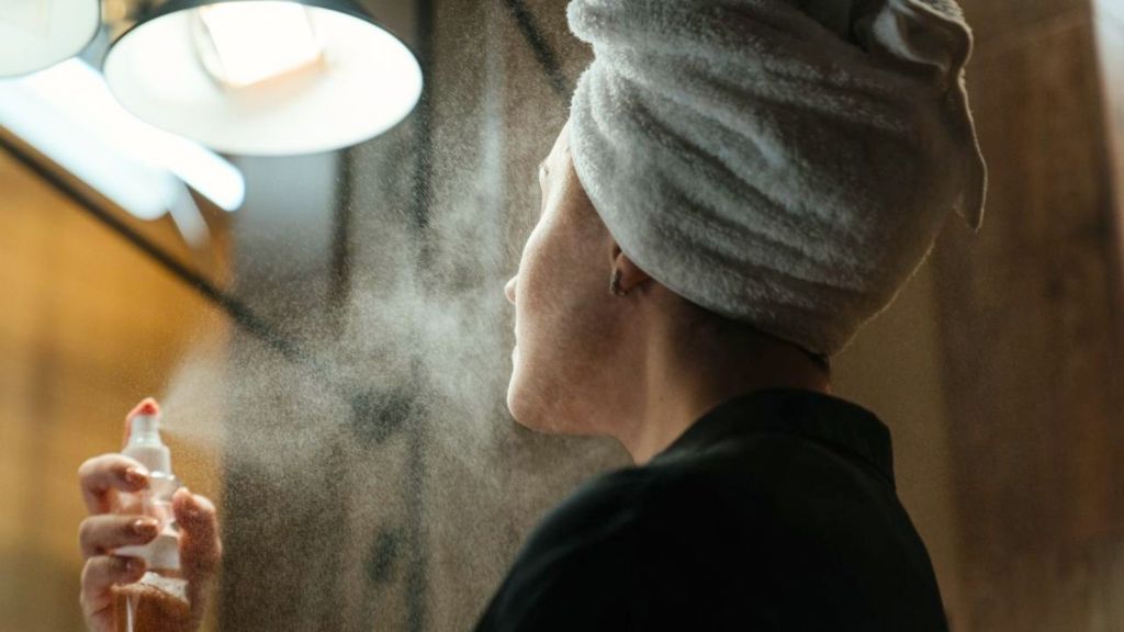 Woman using spray perfume