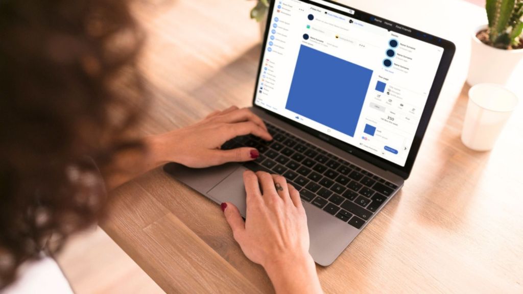 Woman using Facebook on her laptop
