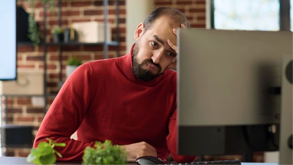 Annoyed man wearing red in office