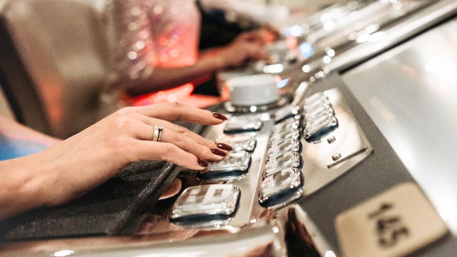 Woman's hand using slot machine