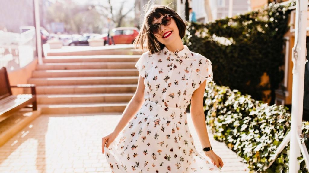 A woman wearing floral white dress