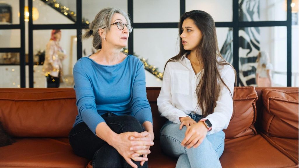 Two women arguing on a couch