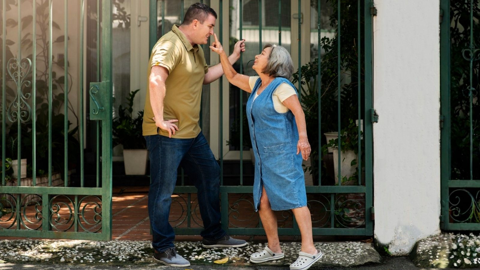 Woman Considers Blocking Neighbor After Repeated Lunch Invitations Feel More Like Interrogations Woman pointing at man at gates