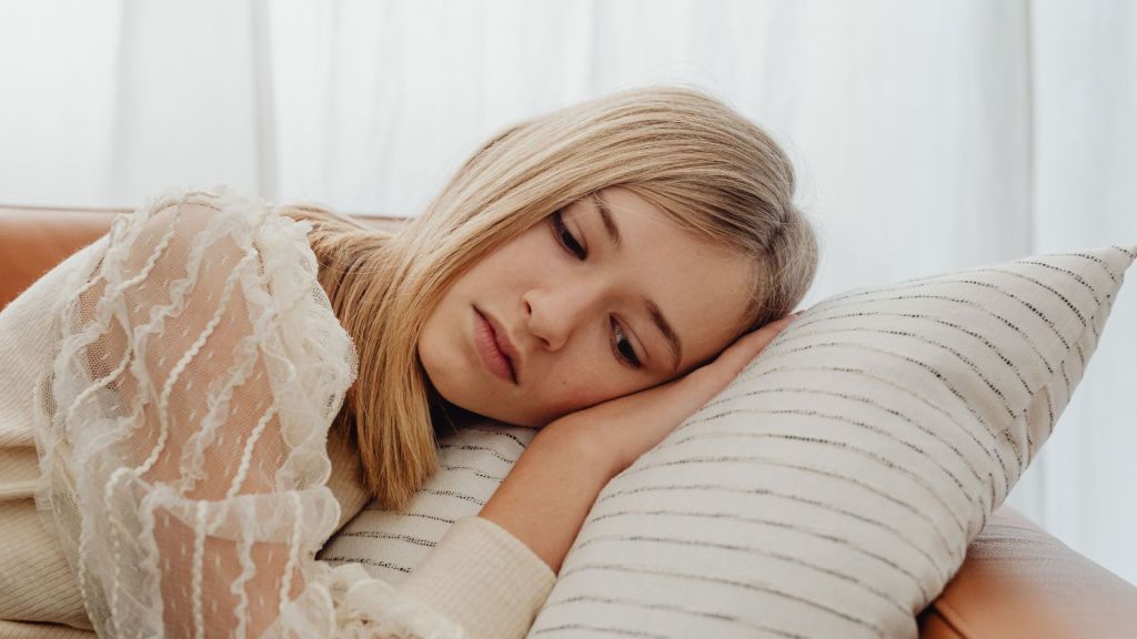 Sad girl lying on a pillow