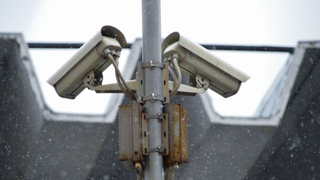 Two surveillance cameras on a pole