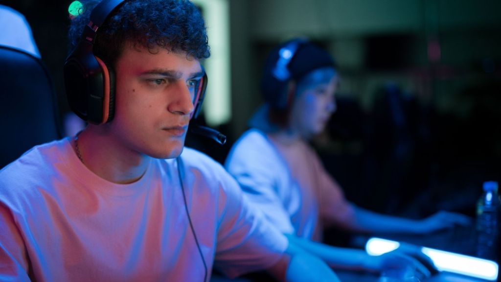 Man wearing headphones using computer