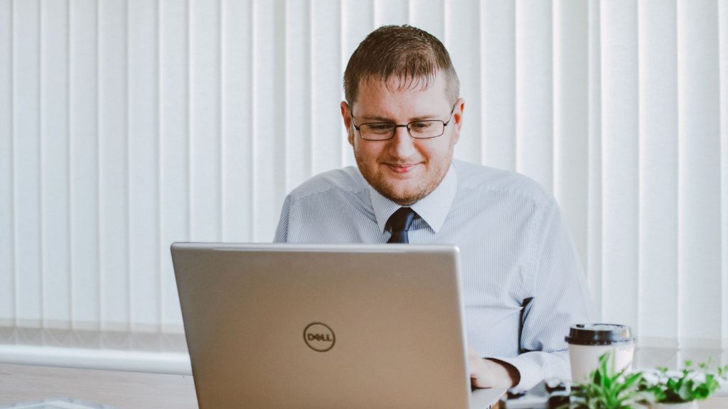 Man in office working on a laptop