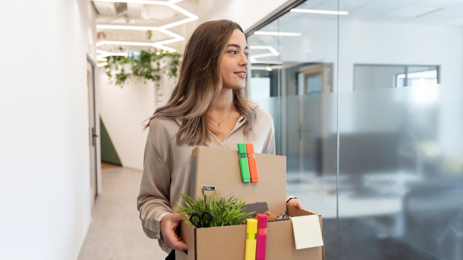 Leaving Was Easy, Forgiving Myself for Staying Was Hard: Woman Opens Up After Quitting Toxic Job Woman happily leaving the office with a box of her things
