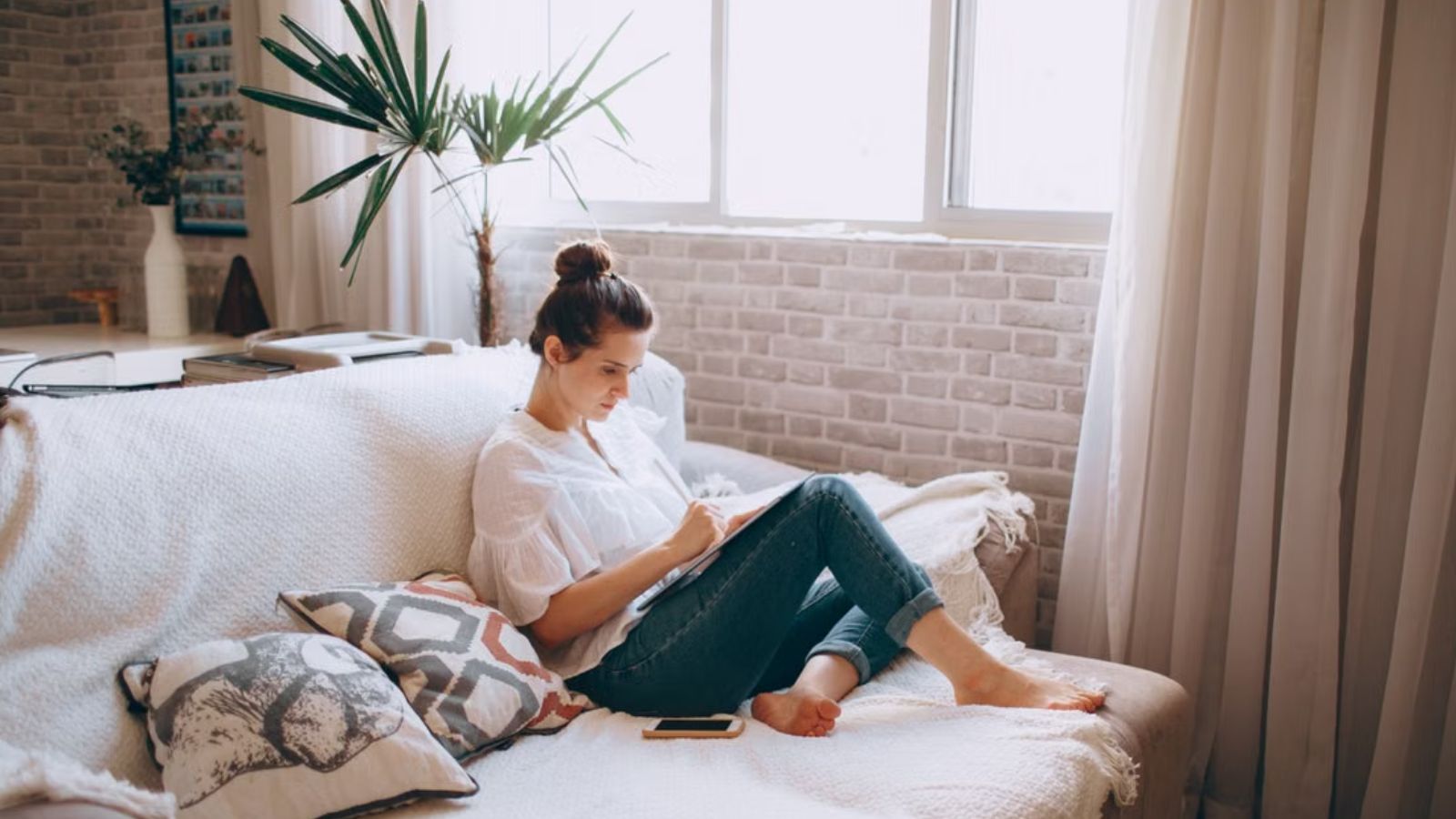 I Did the Math: Woman Reaches Breaking Point When Roommates Mom Accuses Her of Stealing Money Woman reading alone in her apartment