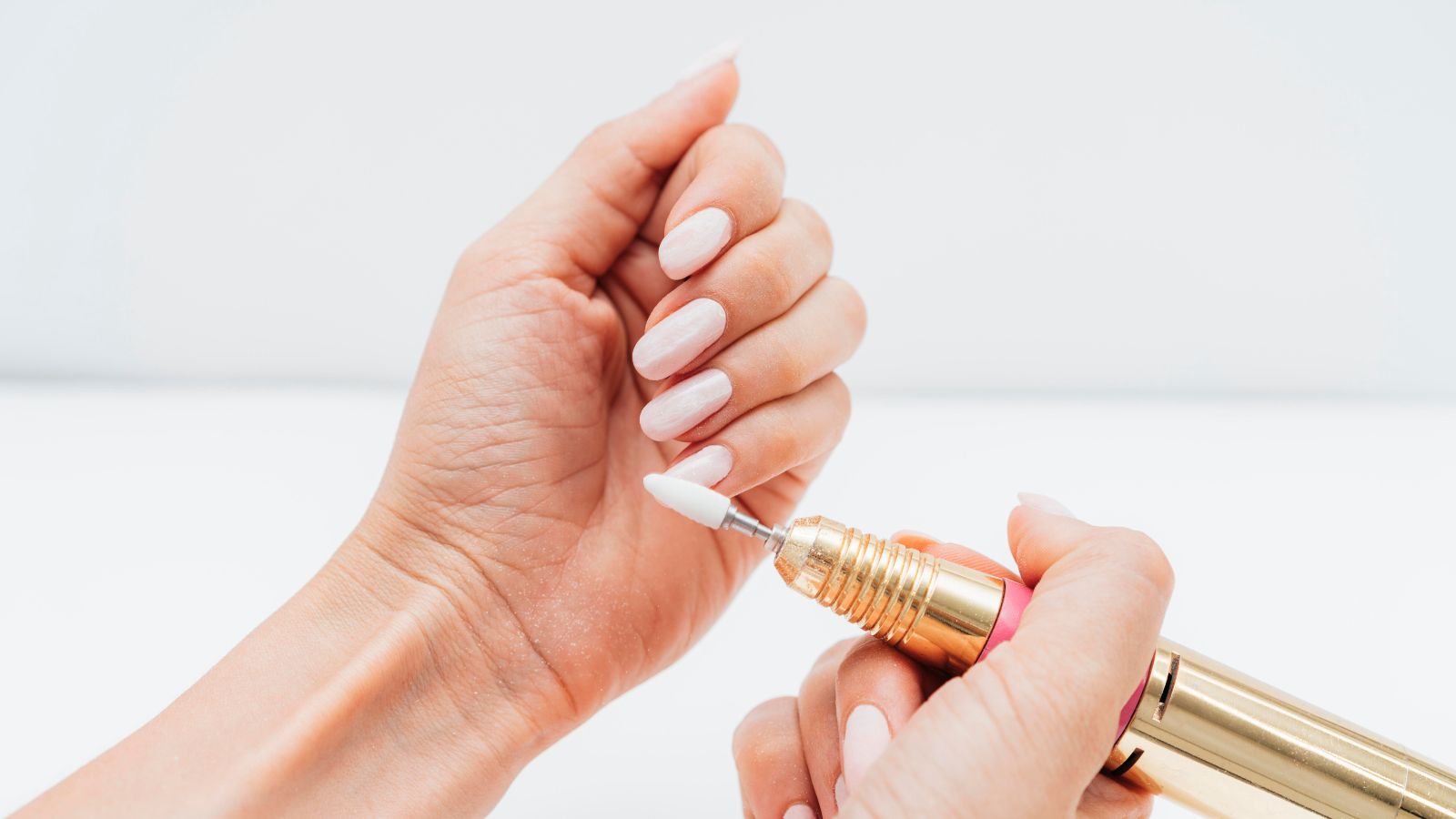 She Had A Secret Collection Hidden In Her Room. Her Parents Cleaned It Out — And Threw It All Away. Woman using a nail file to maintain her long, white nails