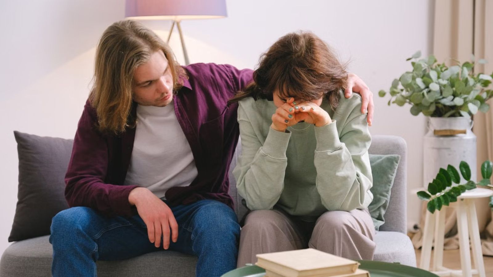 He Chose His Mother in Law Over His Pregnant Wife to Stay in Their Home—and She Called Him Cruel and Unsupportive Young couple sitting on the couch and feeling emotional