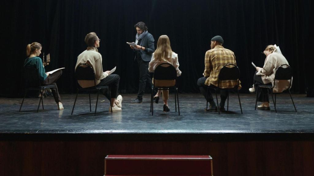 actors on stage rehearsing their parts