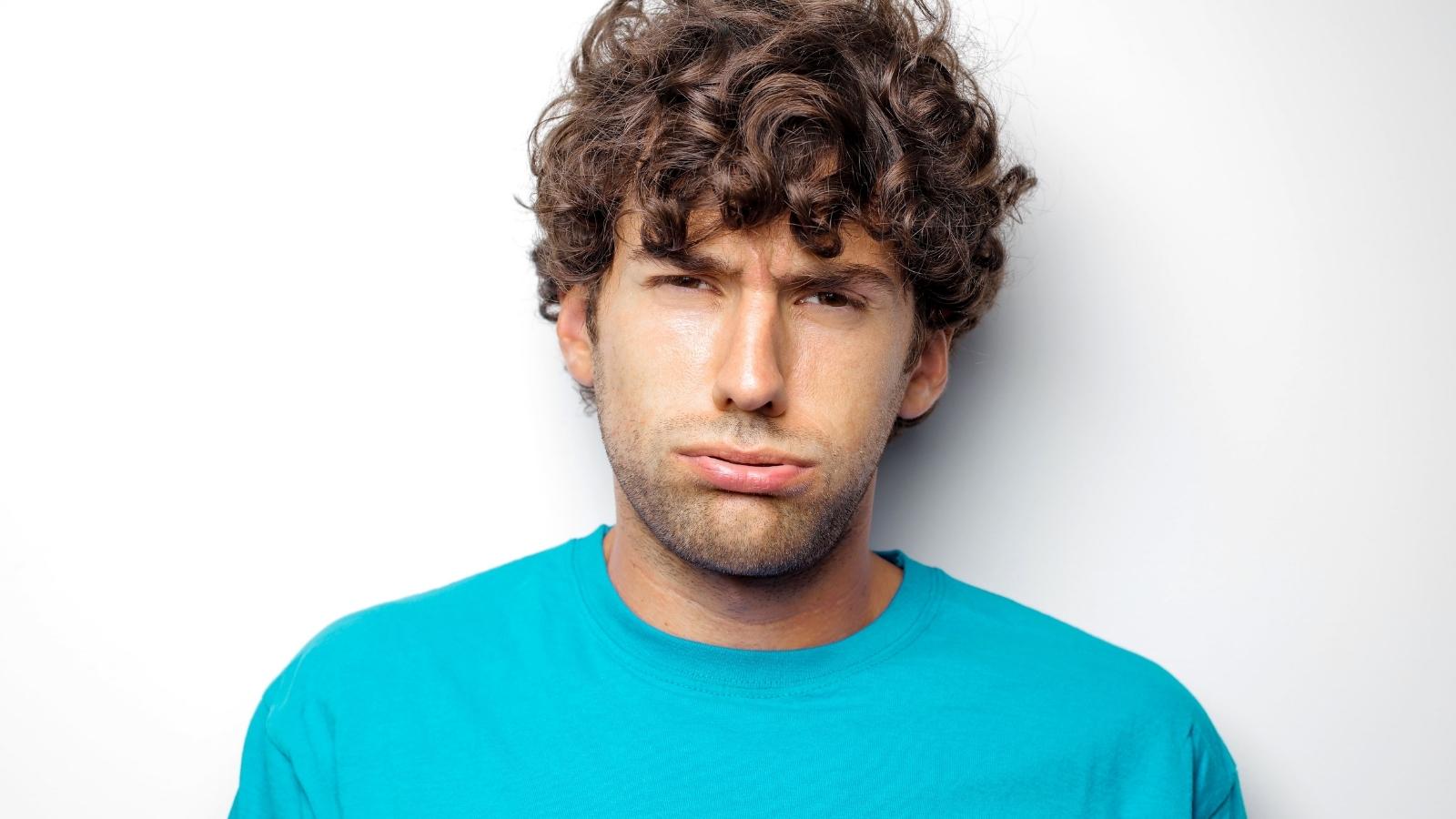 His Dad Thinks 5 Bags Is Too Much for College — He Wants Him Down to Just One Box annoyed college student in blue shirt
