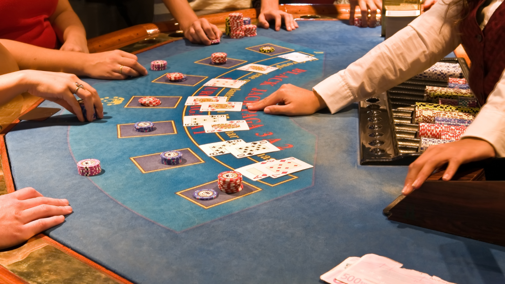 blackjack dealer pointing at cards on table