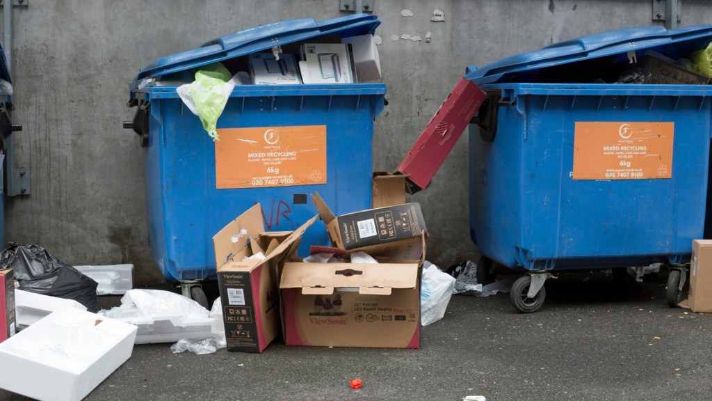 boxes sticking out of shared recycling bins