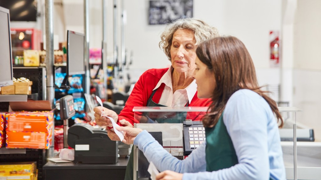 cashier and customer looking over receipt