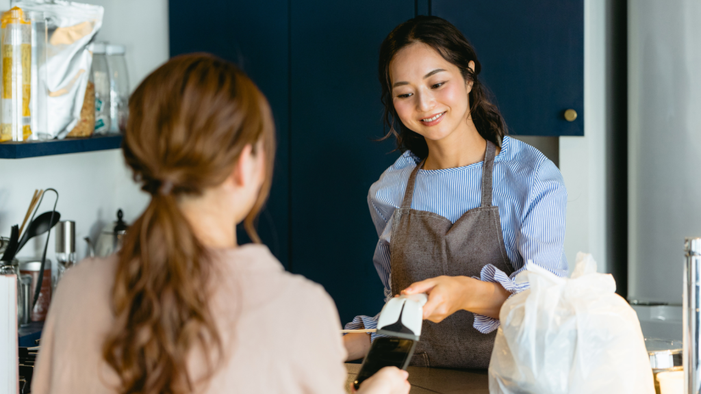 cashier and customer using checkout items