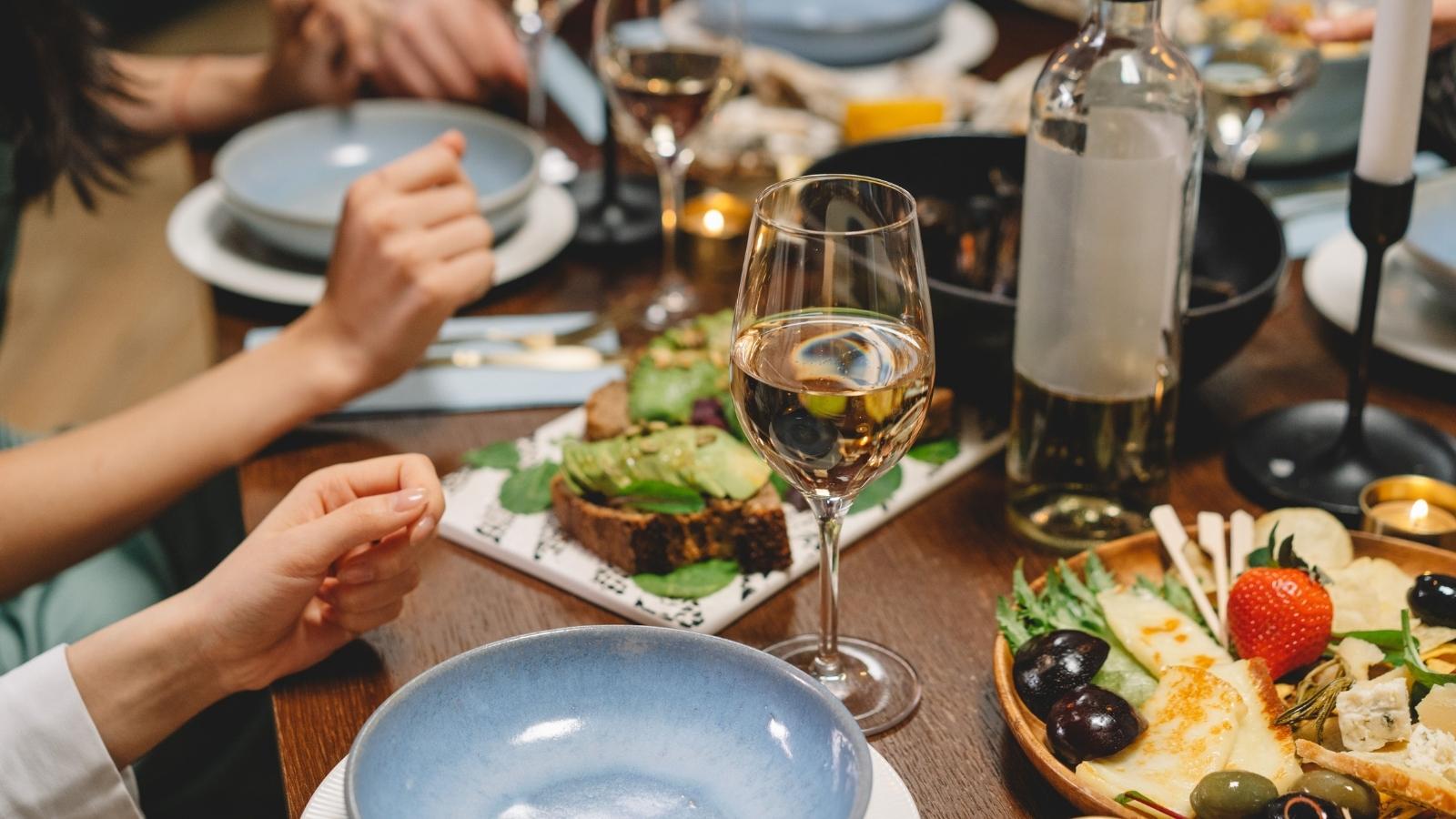 They Use Us for Free Food: Couple Battles Over Cutting Off Parasitic Friend Group close up of dinner table at a dinner party