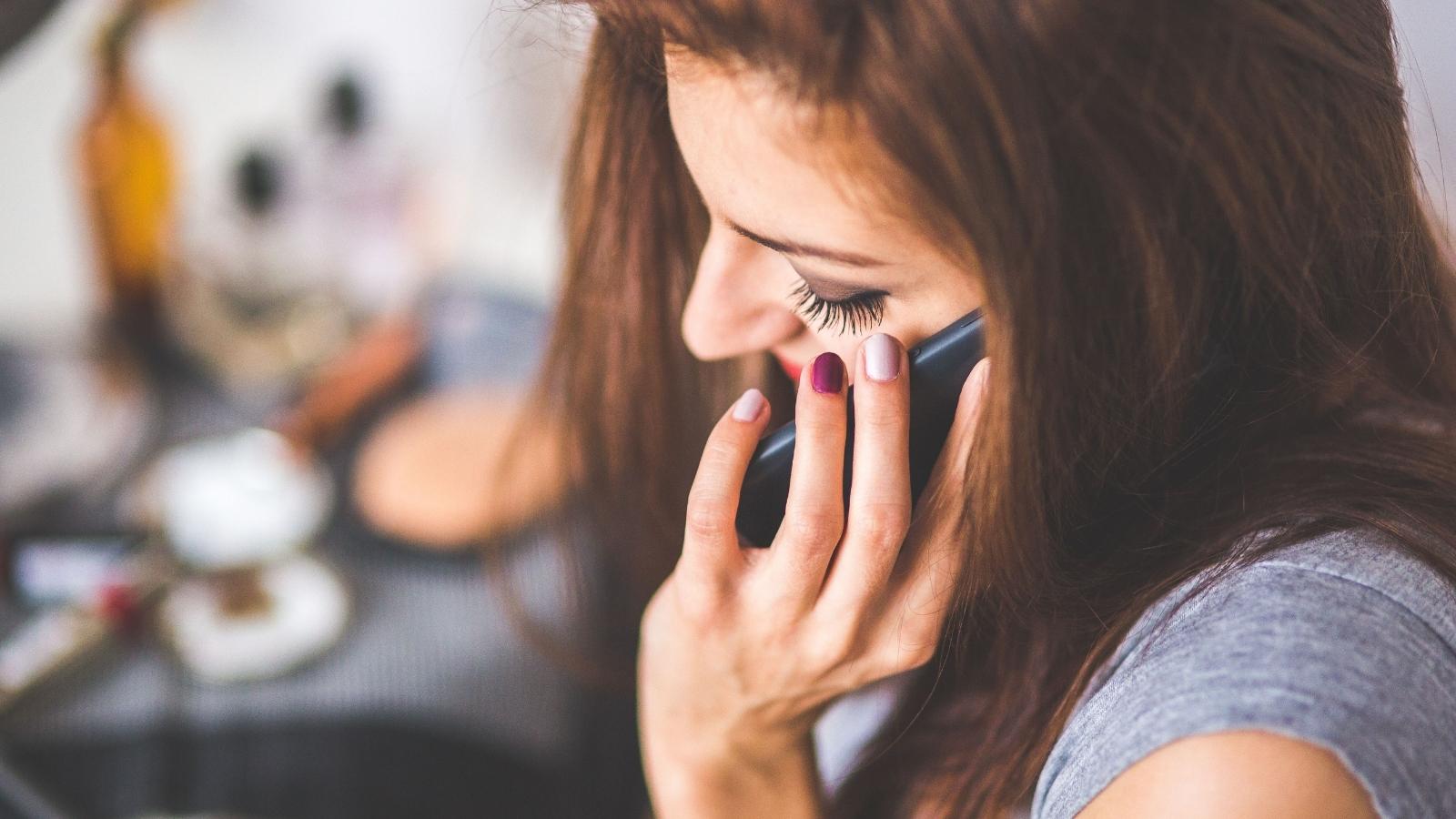 Woman Asks Roommate to Stop Taking Every Call on Speaker, but Gets Called Controlling closeup image of woman talking on the phone