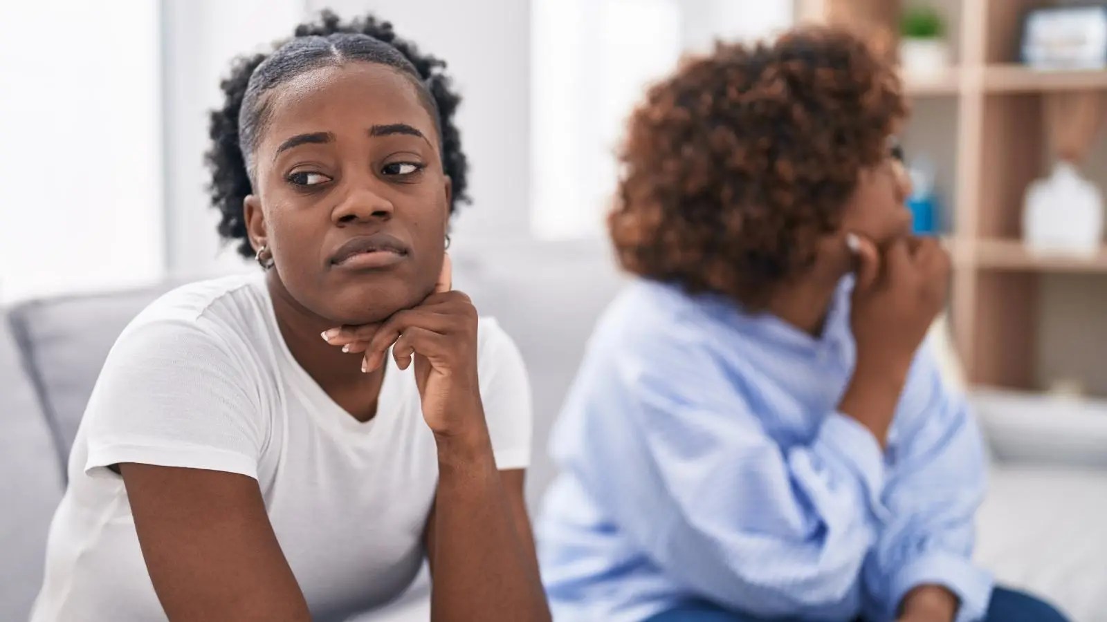 Family Favor Backfires: Woman Wants Her Sister Out After Living Together Goes Wrong two women on a couch