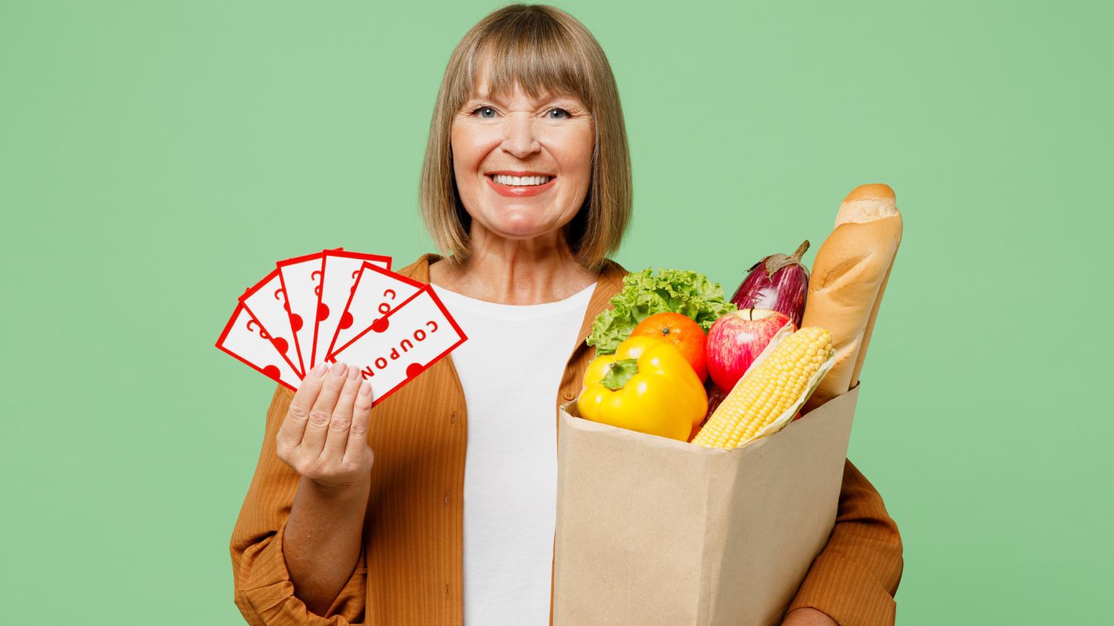 Retail Worker Watches Customer Use Dozens of Coupons to Get Her Shopping for Almost Nothing woman holding a bag of groceries