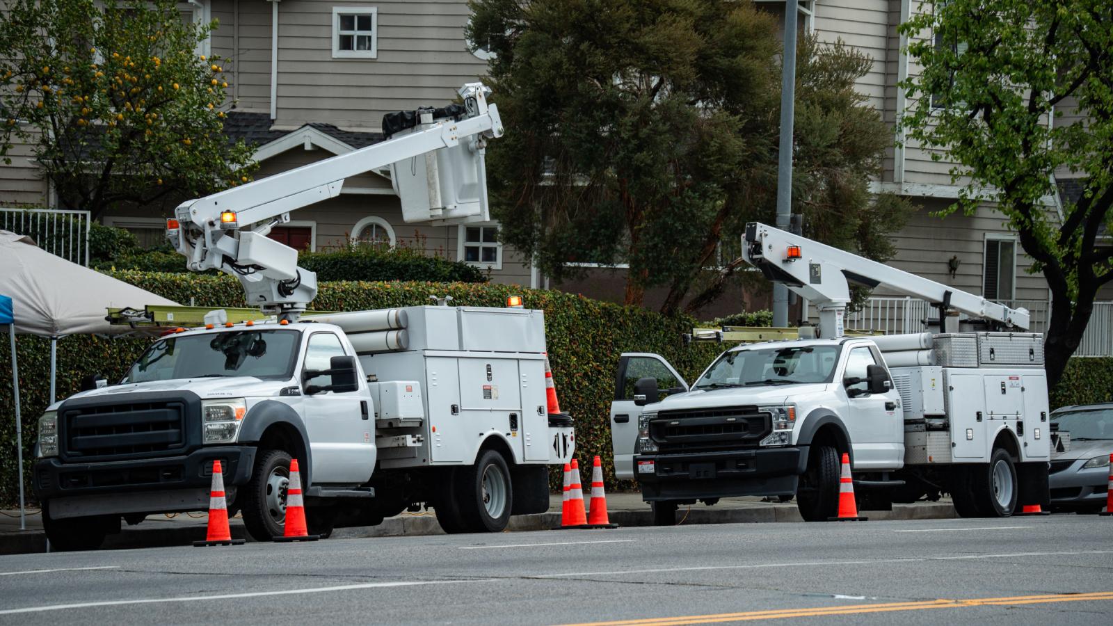 Her Neighbors Keep Reserving Public Street Parking for Private Contractors—and Shes Running Out of Patience work trucks parked on a street