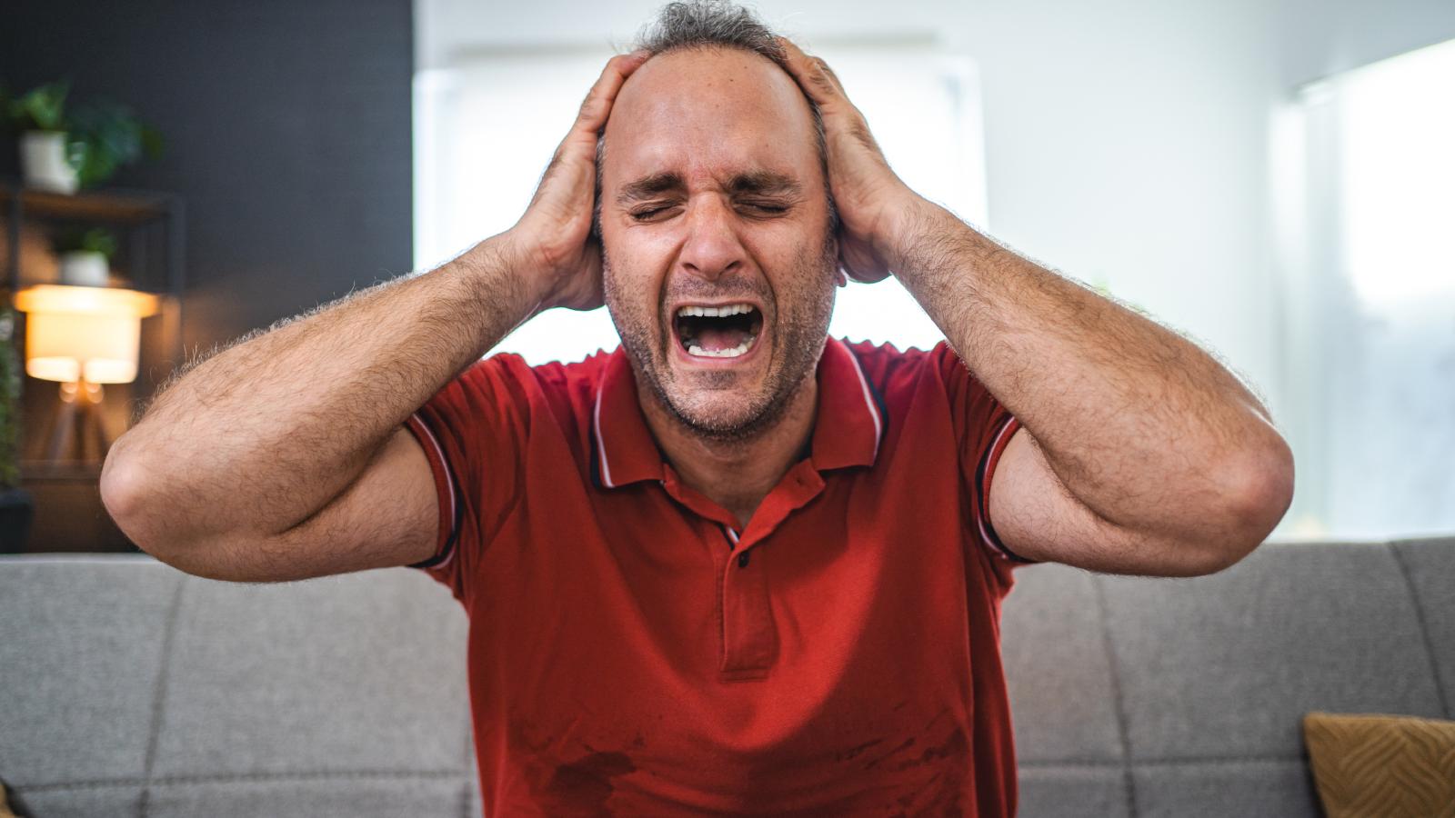 man screaming on a couch