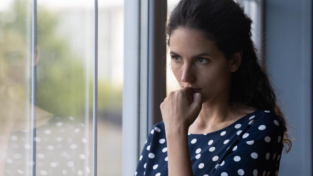 woman looking out a window