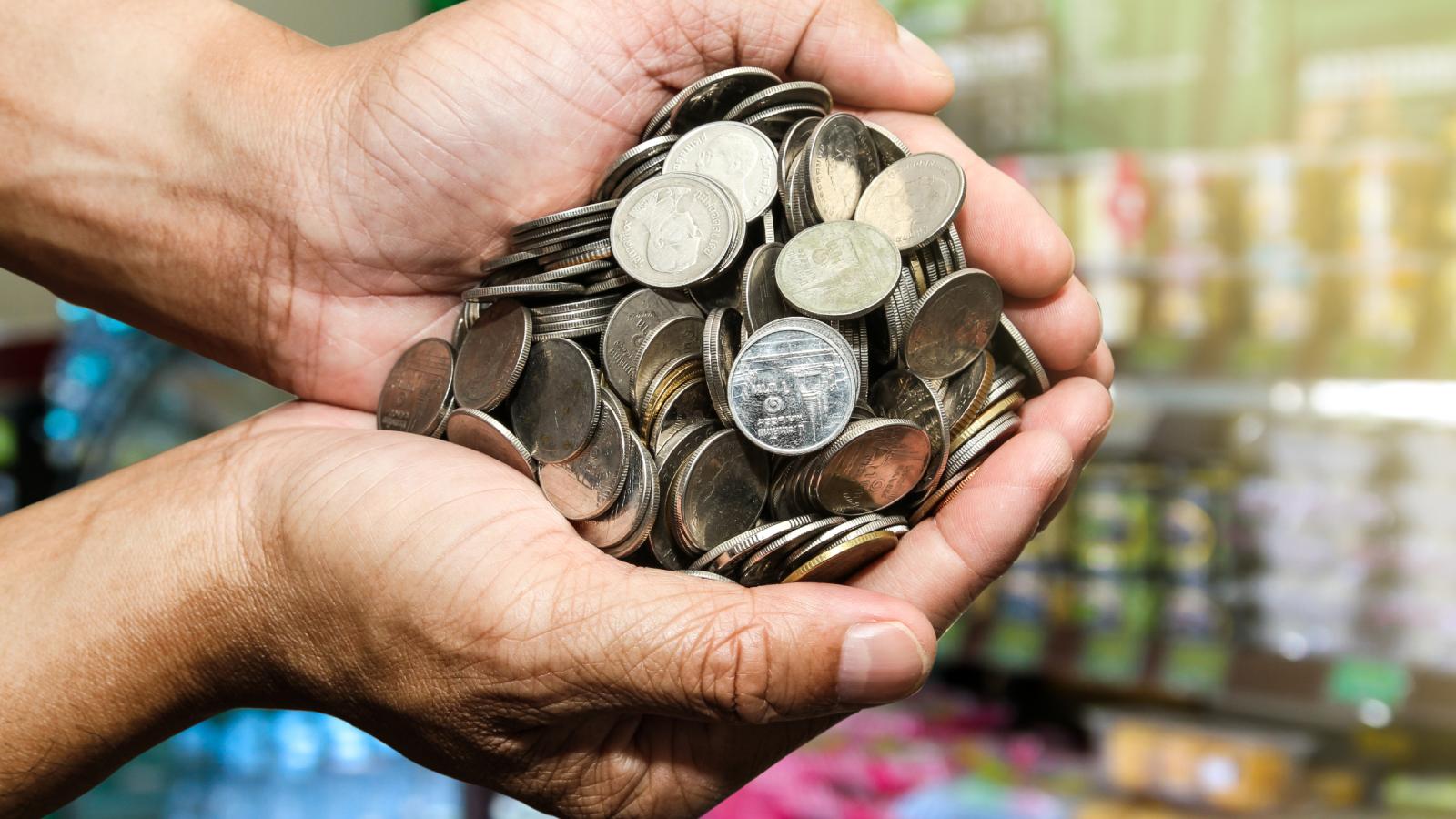 Are You Serious?!: Trial by Fire First Shift Ends in Massive Coin Counting Register Nightmare person with a handful of coins