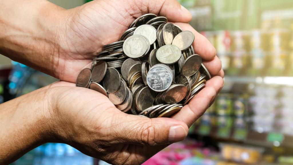 person with a handful of coins
