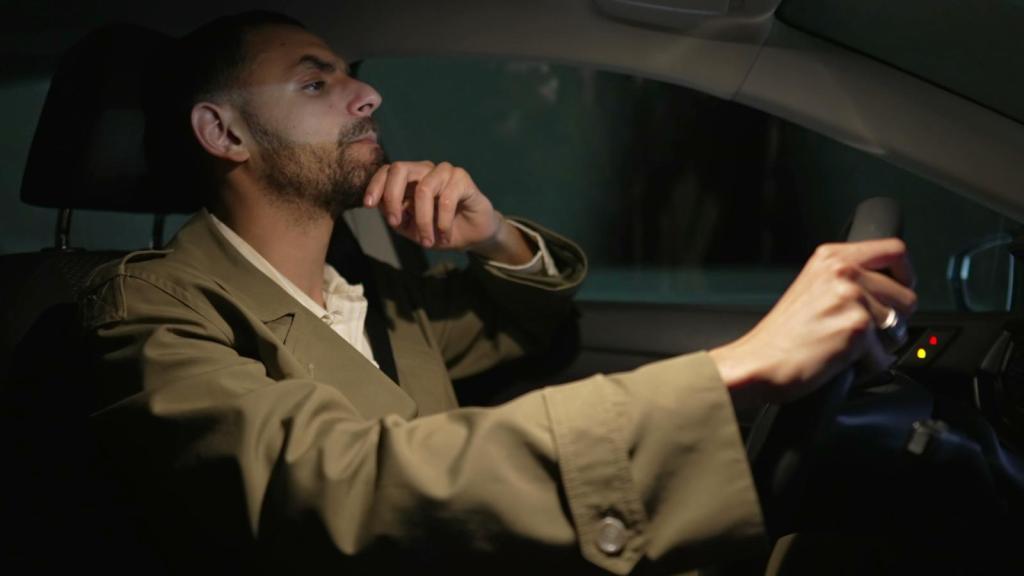 man driving a car