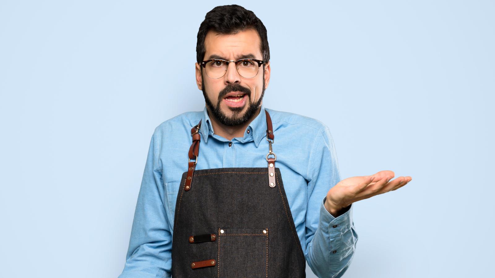 Man Thought Going To Community College Would Land Him An Internship, But Instead, Hes Stuck With Retail Jobs That Overwork Him man shrugging his shouders