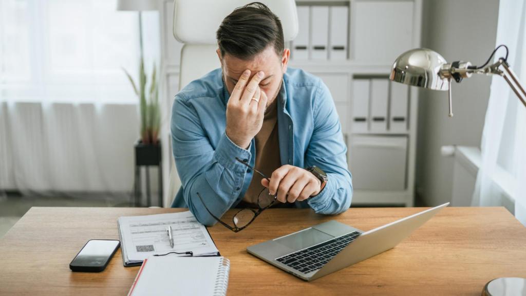 man frustrated at a desk
