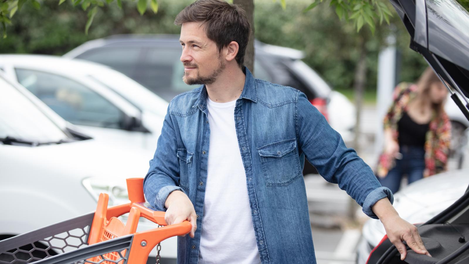 man in a grocery store parking lot