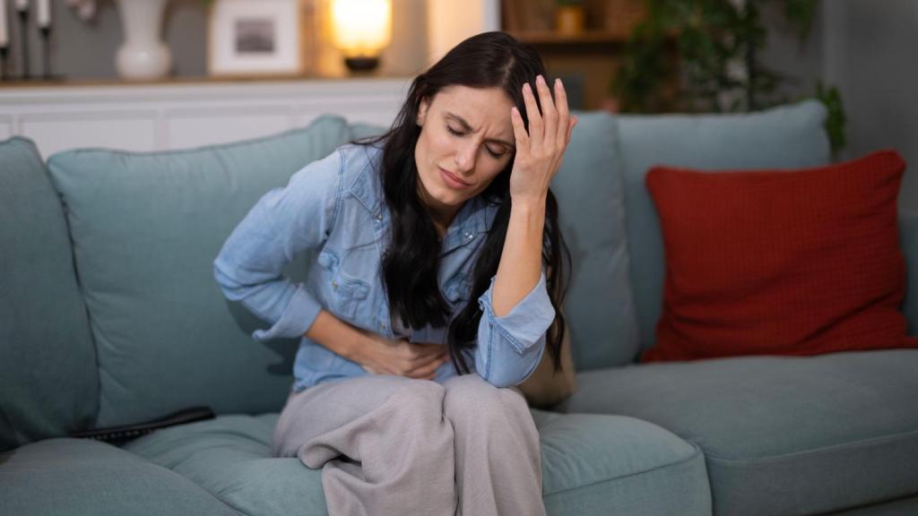 woman feeling sick on a couch