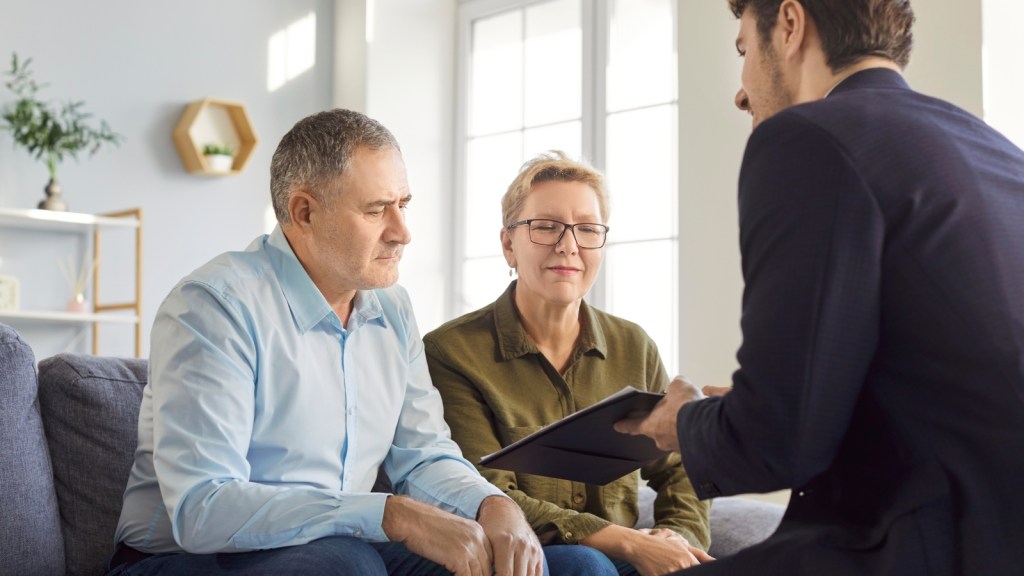 concerned older couple meeting with lawyer