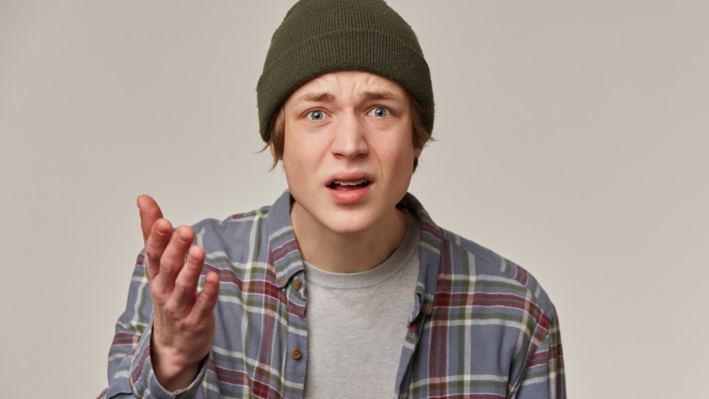 confused displeased young man looking at camera