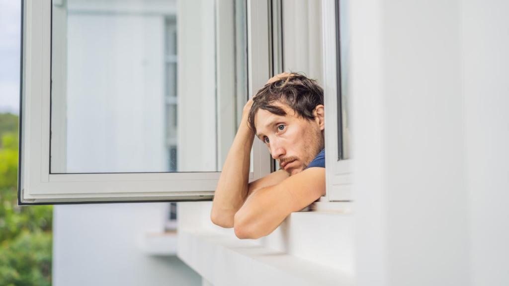 man looking out a window