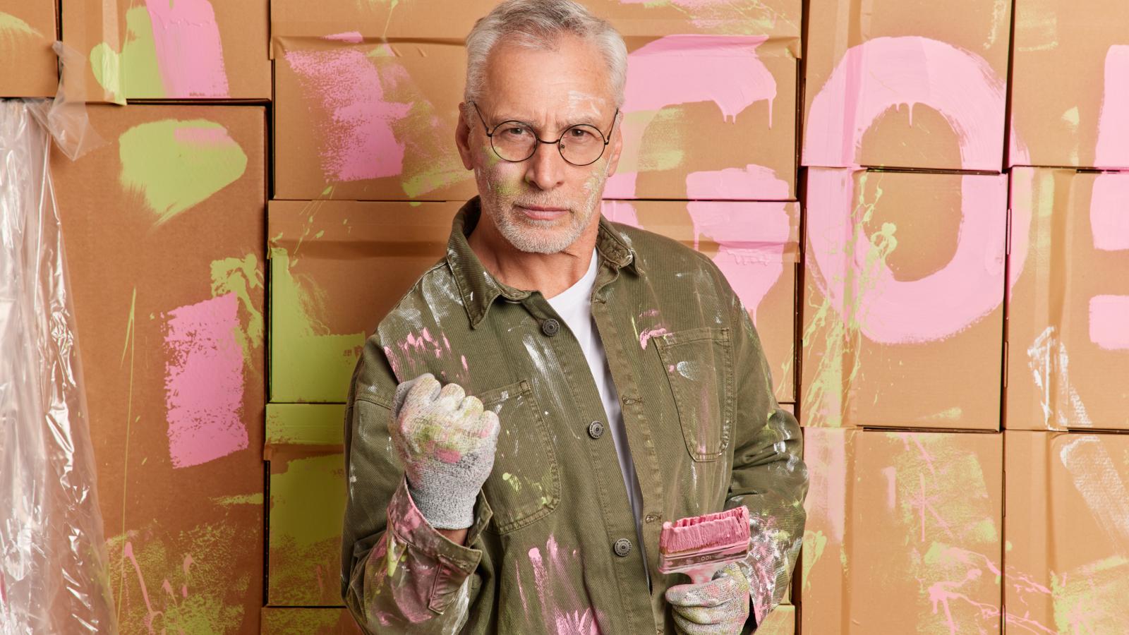 Her Neighbor Was Rejected By Her Mother In Law—Now Hes Making The Whole Family Miserable man holding a paint brush