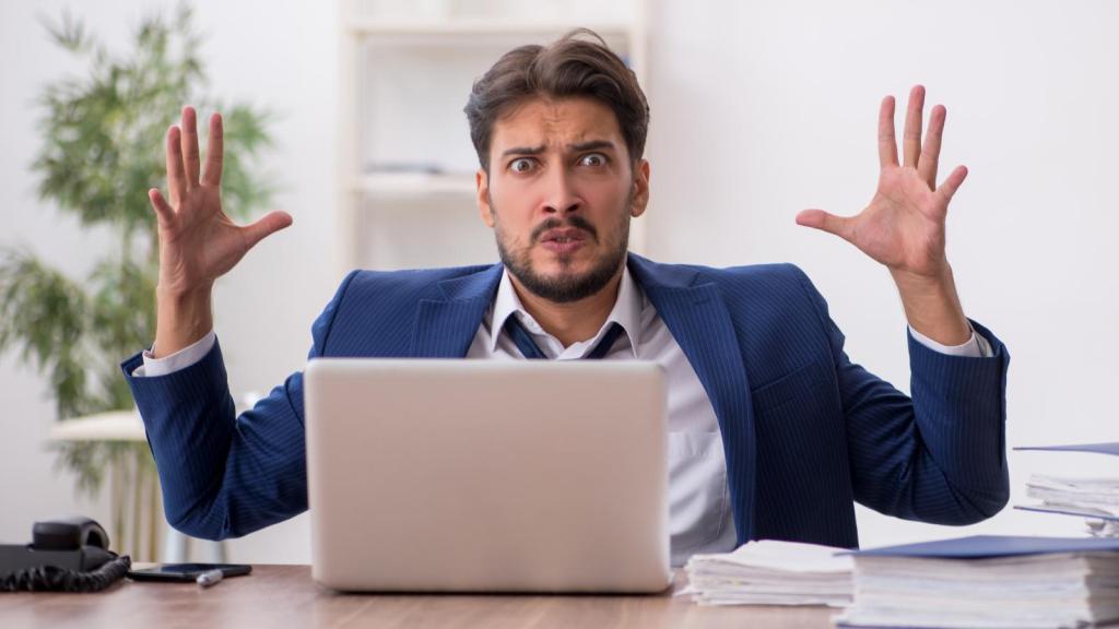 man upset at a desk