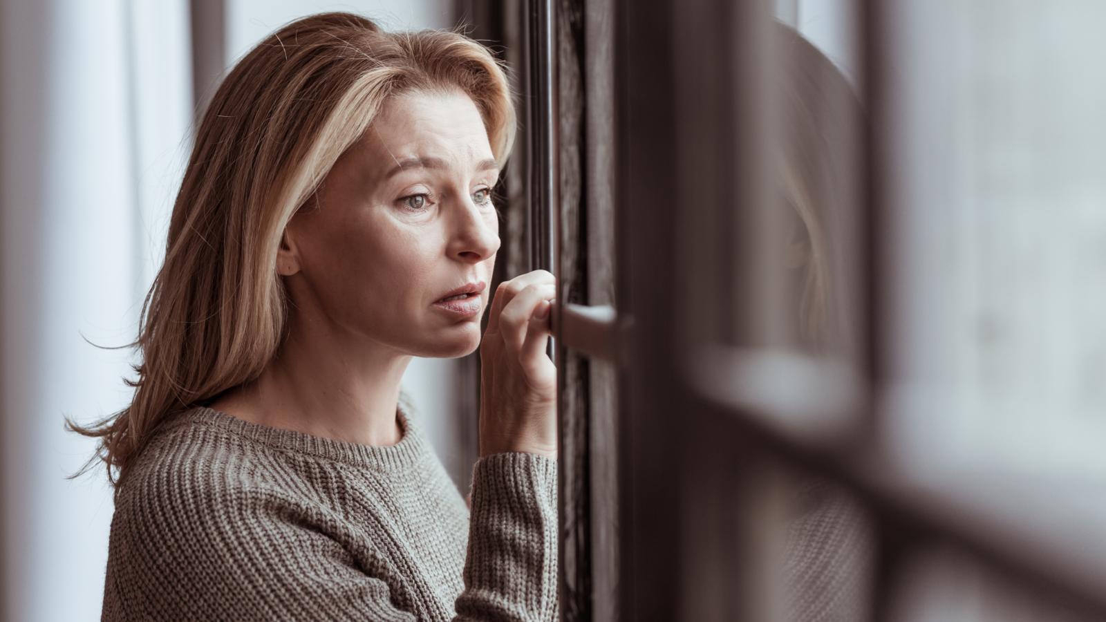 woman looking out a window