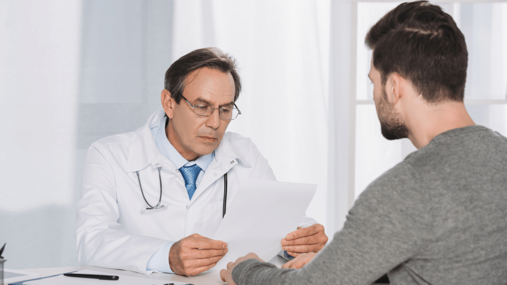 A Woman Set Up Insurance For Her Household, Then Her Mother Asked Her To Include Someone Outside The Family On The Same Plan doctor looking at papers with patient