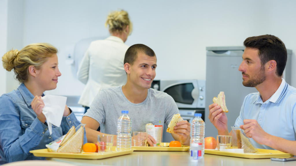 employees eating and laughing in break room